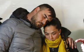 Thursday, Jan. 24, 2019, Jose Rosello and Victoria Garcia, parents of 2-year-old boy trapped in a deep borehole, take part on a vigil at the town of Totalan near Malaga, Spain.