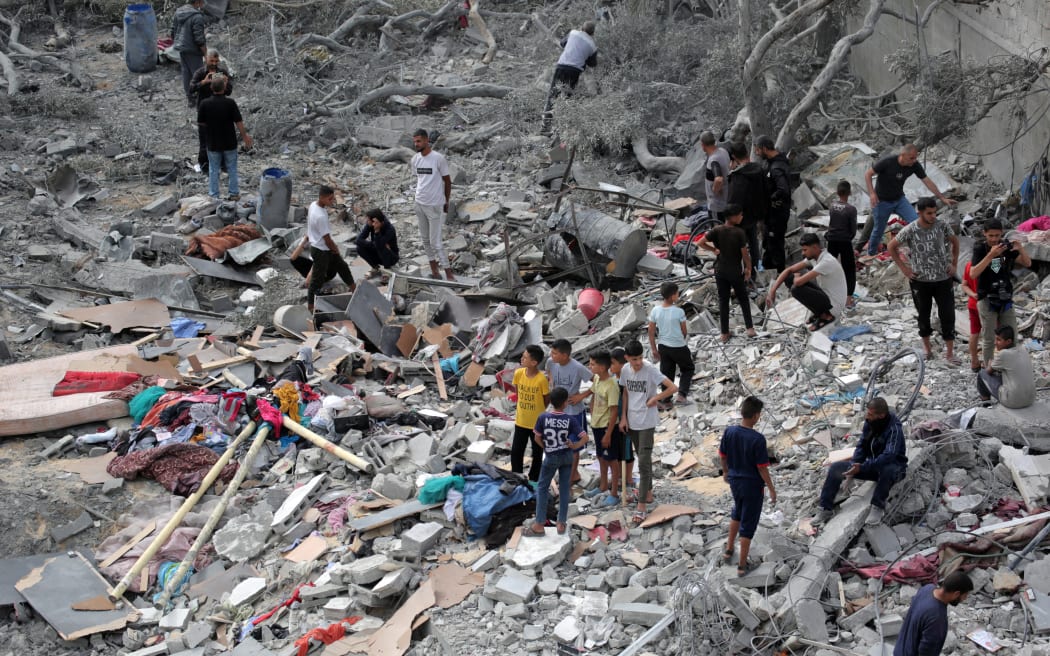 Palestinians check the rubble of a residential building destroyed by an Israeli strike in Al-Zawayda in the central Gaza Strip on May 11, 2024, amid the ongoing conflict between Israel and the Hamas movement.