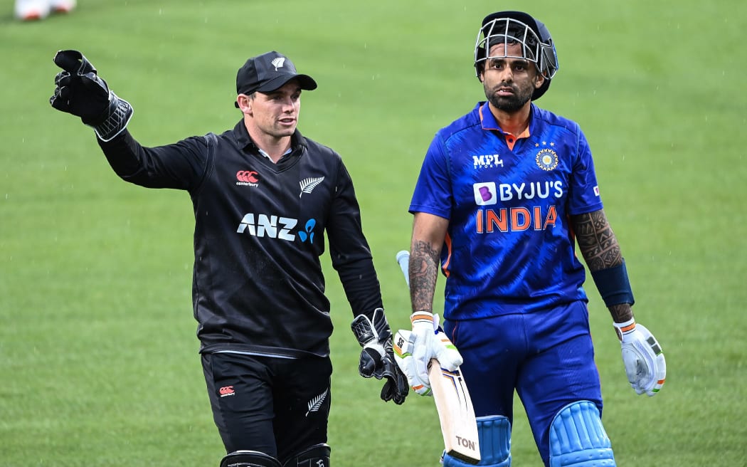 New Zealand's Tom Latham and India's Suryakumar Yadav leave the field during the second One Day International in Hamilton.