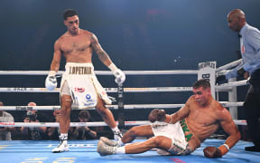Australian Jai Opetaia knocks down opponent David Nyika of New Zealand during the Ring Magazine and IBF World Cruiserweight title fight  in Gold Coast, 2025.