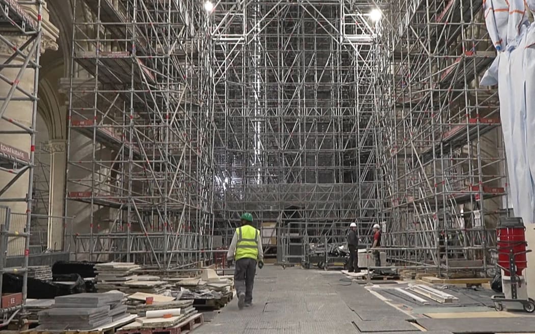 This video grab created from an AFP video taken on April 11, 2024, shows scaffolding inside Paris Notre-Dame cathedral under restoration since the devastating fire that ravaged it on April 15, 2019. A tender for the creation of contemporary stained-glass windows was launched on April 11, 2024. The iconic Parisian monument is scheduled to reopen in December 2024. (Photo by Mathilde BELLENGER / AFP)