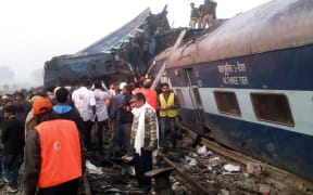 Indian rescue workers search for survivors in the wreckage of the derailed train.