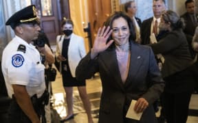 US Vice President Kamala Harris waves as she departs the Senate after passage of the Inflation Reduction Act at the US Capitol on 7 August, 2022 in Washington, DC. The final vote was 51-50, with the tie-breaking vote being cast by Harris.