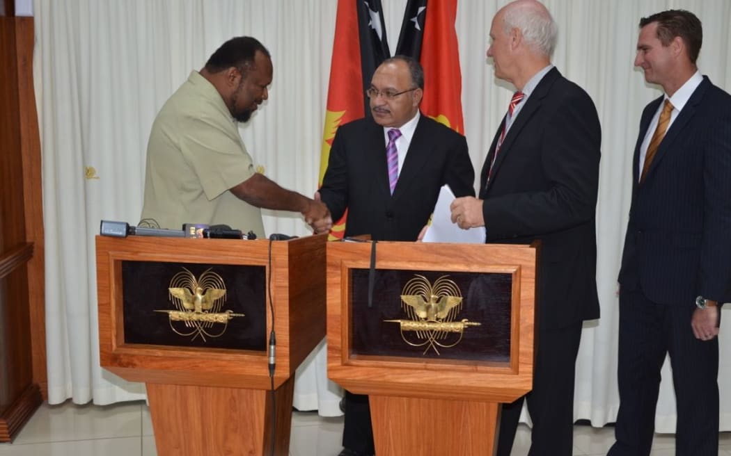 Papua New Guinea Public Enterprises Minister Ben Micah, Prime Minister Peter O'Neill, ExxonMobil PNG Managing Director Peter Graham, and ExxonMobil PNG Production Manager Andrew Barry.