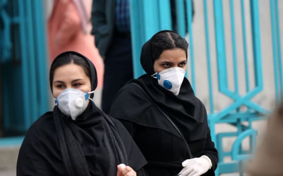 People wear masks after deaths and new confirmed cases revealed from the coronavirus in Tehran, Iran.