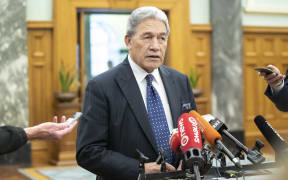 Winston Peters speaks to media on his way to the debating chamber in Parliament, Wellington.