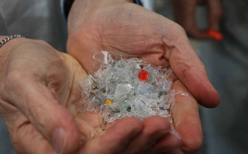Plastic flakes, washed and broken up, ready to become semi molten before being extruded into plastic sheets for reincarnation as another plastic item at Flight Plastics.
