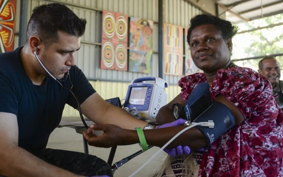Papua New Guinea (July 7, 2015) Hospitalman Jaime Cavalleroserna, from San Francisco, takes patient vitals during a community health engagement. Medical personnel from the hospital ship USNS Mercy (T-AH 19) arrived in Kokopo  during Pacific Partnership 2015.