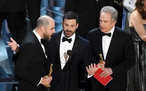 La La Land' producer Jordan Horowitz (left) announces actual Best Picture winner as 'Moonlight' after a presentation error with host Jimmy Kimmel and actor Warren Beatty onstage.