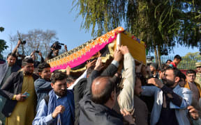 Mourners carry the coffin of Malalai Maiwand, who was shot dead by gunmen in Jalalabad.