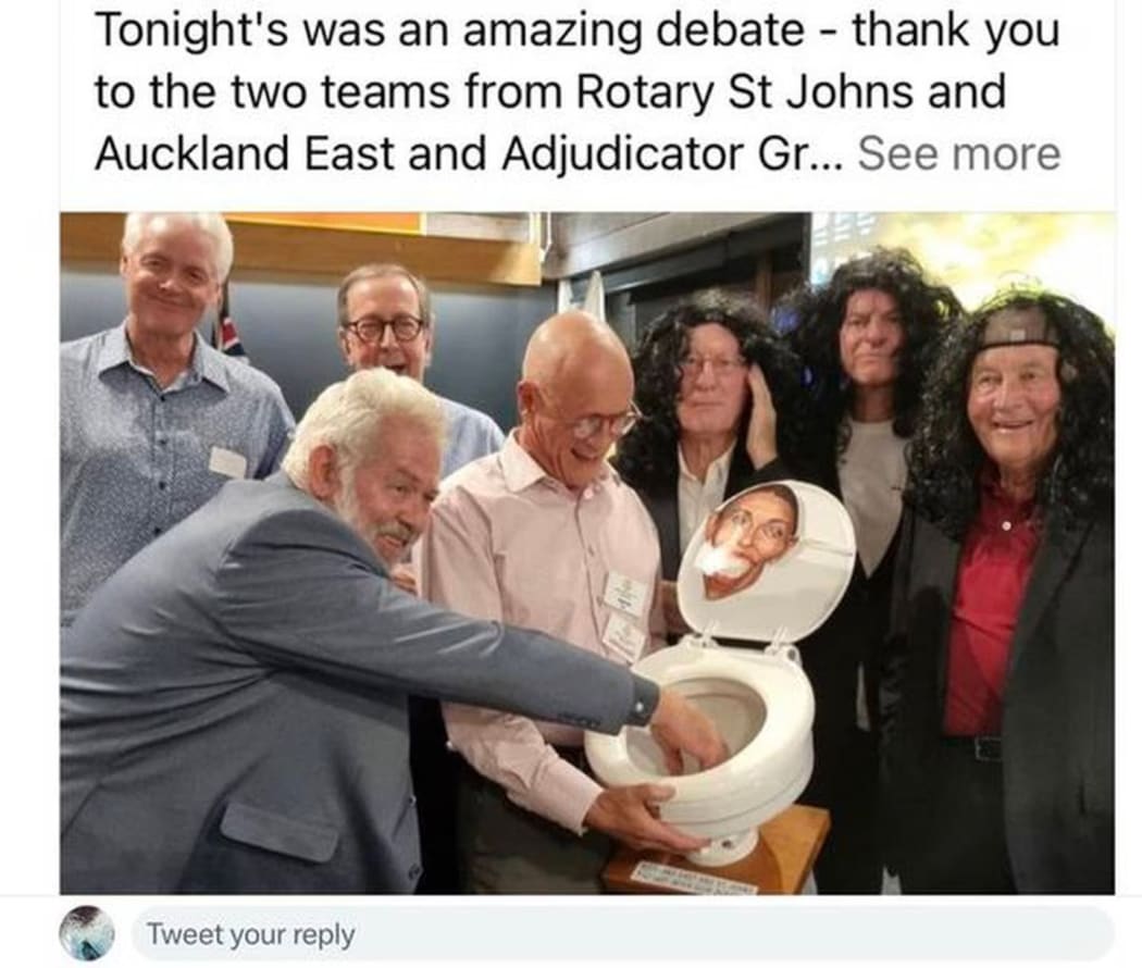 A screenshot of the now-deleted post taken by the New Zealand Herald shows a group of men surrounding the toilet seat with a caricature of former Prime Minister Jacinda Ardern seemingly stuck to the lid.