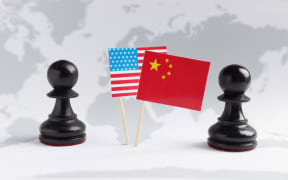 Chess pieces, American and Chinese flags on world map. Trade war concept