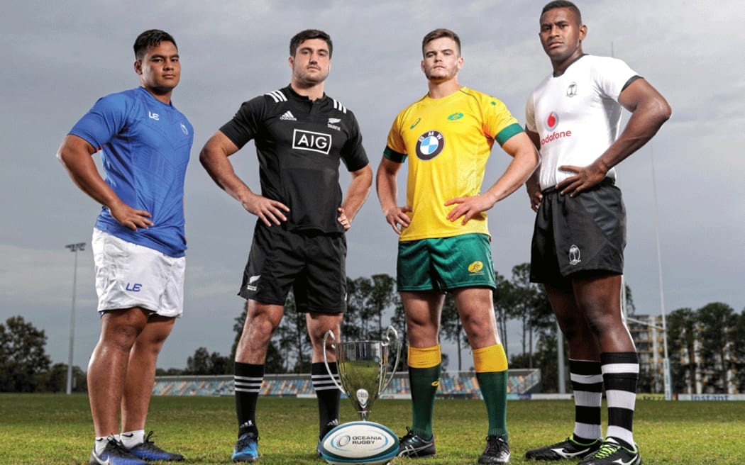 The captains of Samoa, New Zealand, Australia and Fiji pose with the Oceania U20 Rugby Championship trophy.