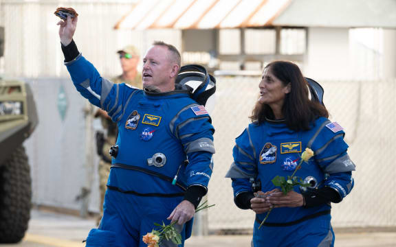 NASA astronauts Butch Wilmore, left, and Suni Williams, wearing Boeing spacesuits, are seen as they prepare to depart the Neil  A. Armstrong Operations and Checkout Building for Launch Complex 41 on Cape Canaveral Space Force Station to board the Boeing CST-100 Starliner spacecraft for the Crew Flight Test launch, Wednesday, June 5, 2024, at NASA’s Kennedy Space Center in Florida. NASA’s Boeing Crew Flight Test is the first launch with astronauts of the Boeing CFT-100 spacecraft and United Launch Alliance Atlas V rocket to the International Space Station as part of the agency’s Commercial Crew Program. The flight test, targeted for launch at 10:52 a.m. EDT, serves as an end-to-end demonstration of Boeing’s crew transportation system and will carry NASA astronauts Butch Wilmore and Suni Williams to and from the orbiting laboratory.  Photo Credit: (NASA/Joel Kowsky)