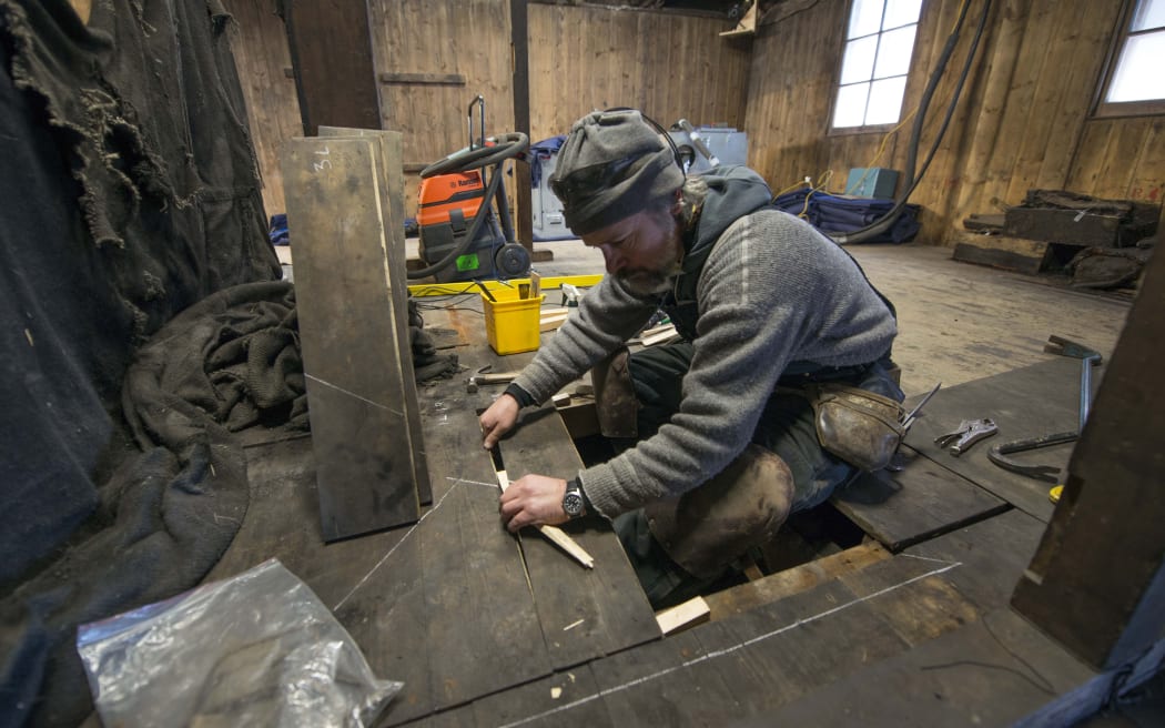 Lead carpenter Gordon Macdonald lifts the floorboards at Scott’s Discovery Hut.