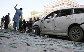 Afghan police officers inspect the scene of a suicide bomb attack that targeted a voter registration center in Kabul, Afghanistan on April 22, 2018.