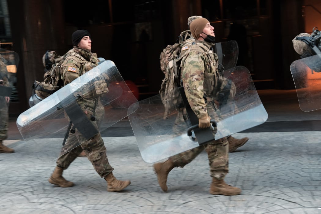 Members of the National Guard walk through the streets as Washington DC remains under tight security during the presidential inauguration