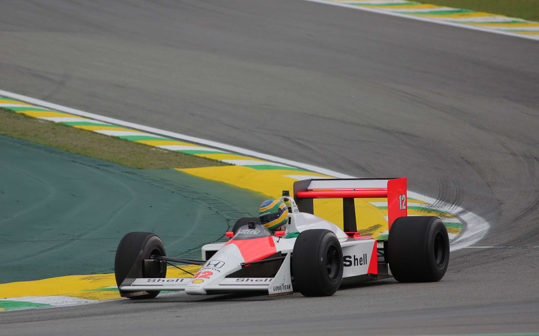 Bruno Senna driving the 1988 McLaren MP4/4 raced by his uncle Ayrton Senna.