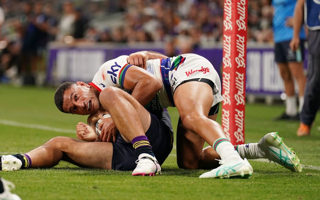Marcelo Montoya is held up over the line by Jahrome Hughes.