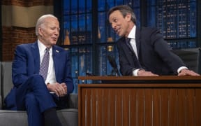 (L-R) US President Joe Biden speaks with host Seth Meyers during a taping of "Late Night with Seth Meyers" in New York City on February 26, 2024. (Photo by Jim WATSON / AFP)