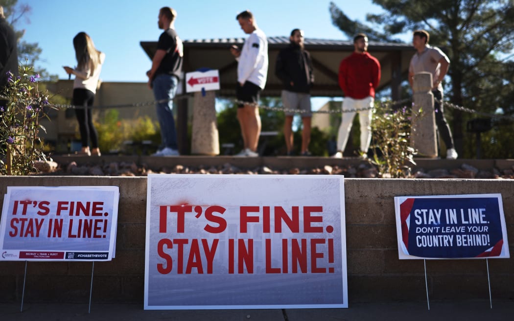 SCOTTSDALE, ARIZONA - NOVEMBER 05: Voters wait in line to cast their ballots at a polling place on November 05, 2024 in Scottsdale, Arizona. Americans cast their ballots today in the presidential race between Republican nominee, former President Donald Trump and Democratic nominee, Vice President Kamala Harris, as well as multiple state elections that will determine the balance of power in Congress.   Mario Tama/Getty Images/AFP (Photo by MARIO TAMA / GETTY IMAGES NORTH AMERICA / Getty Images via AFP)