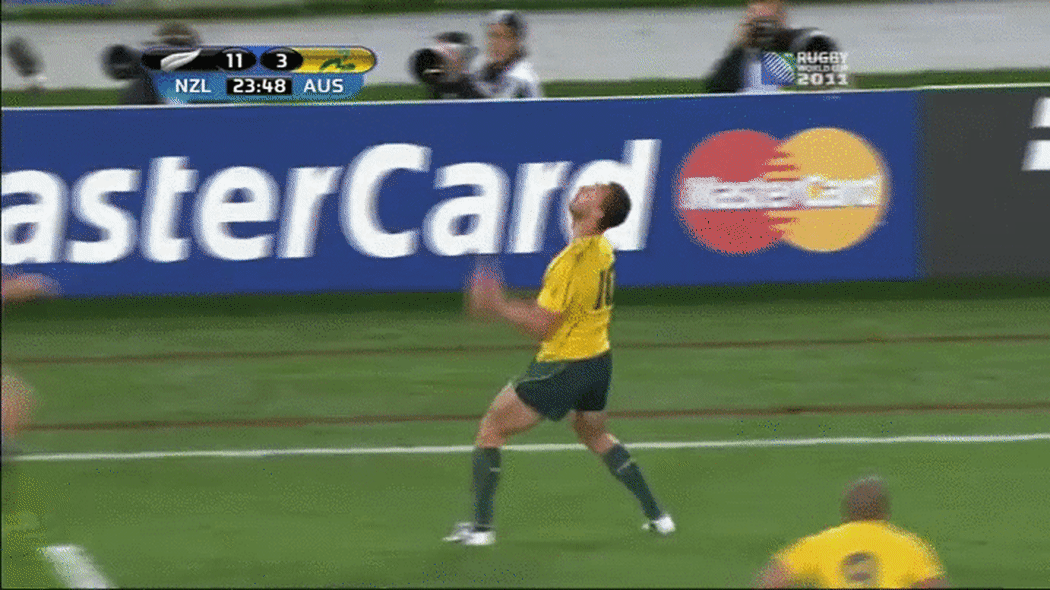 All Black Richard Kahui tackles Wallaby Quade Cooper.