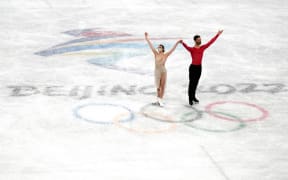 Gold medalists France's Gabriella Papadakis and Guillaume Cizeron pose during the flower ceremony for the ice dance figure skating event during the Beijing 2022 Winter Olympic Games at Capital Indoor Stadium in Beijing, China