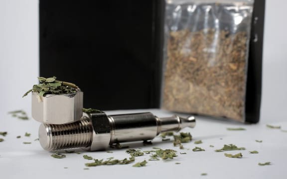 Synthetic cannabis and a pipe.