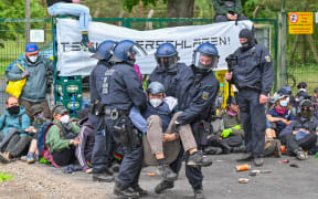 Police clear a blockade by activists at the access road to Neuhardenberg airfield on 10 May 2024. Tesla vehicles produced at the Grünheide plant are temporarily stored on the airfield site. The situation at the demonstrations around the Tesla site has calmed down for the time being. A large number of activists are currently on the highway on their way back to the protest camp, a police spokesperson said in the early afternoon.