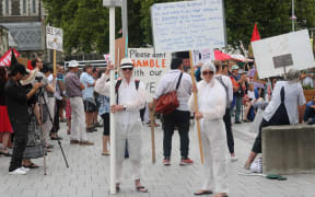 About 200 anti-5G protesters have swarmed central Christchurch with placards, hazmat suits and songs about radiation.