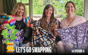 Three smiling women sit together indoors, each holding up colorful second-hand clothing items for a swap. One wears a rainbow jacket, another a floral dress, and the third a light pink top. A money tree icon and bold text at the bottom read 'Let’s Go Swapping – S4 Episode 4'.