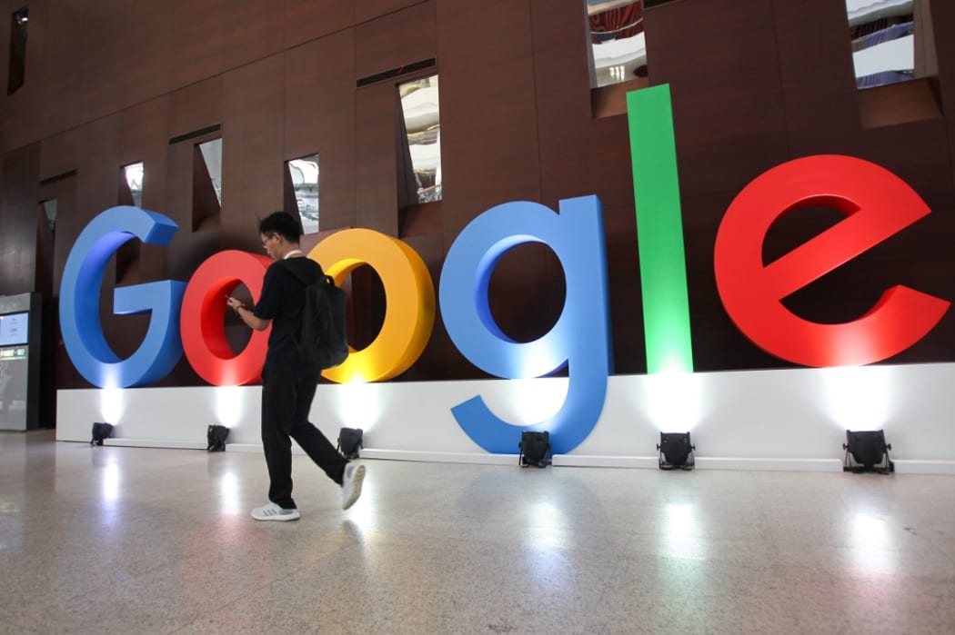A guy walks past the Google logo set up for the Google Developers Day in Shanghai, China, 10 September 2019.