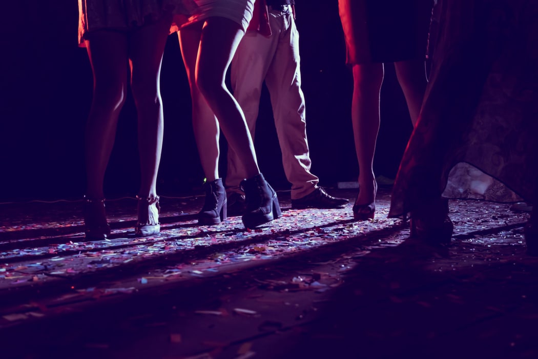 Legs of dancing people dancing at a party.