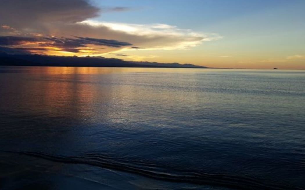 Sunset over a calm ocean in Bougainville.