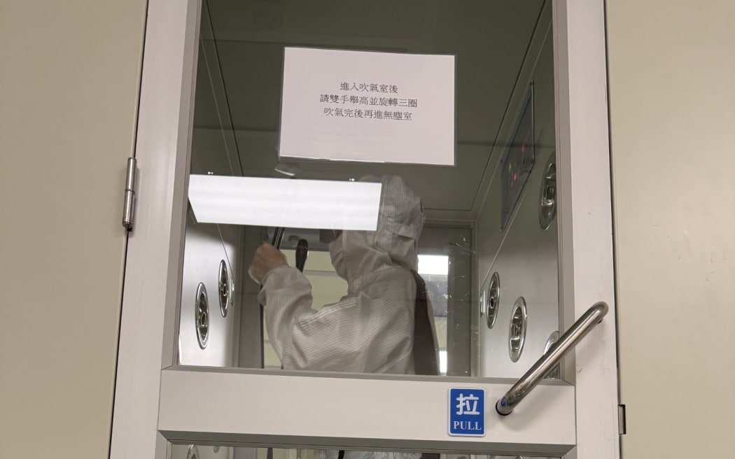 Sharon takes an air shower before going into the clean room