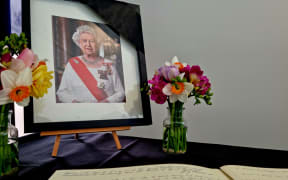 People fill out messages of condolences in a book at the Beehive after the death of Queen Elizabeth II, on 9 September, 2022.