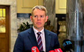 Chris Hipkins speaks to reporters on Parliament's black and white tiles on 19 September.