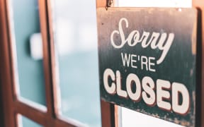Old Close sign hanging front of cafe mirror door. Business service and food drink concept. Vintage tone filter effect color style.
