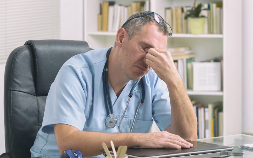 Overworked doctor sitting in his office