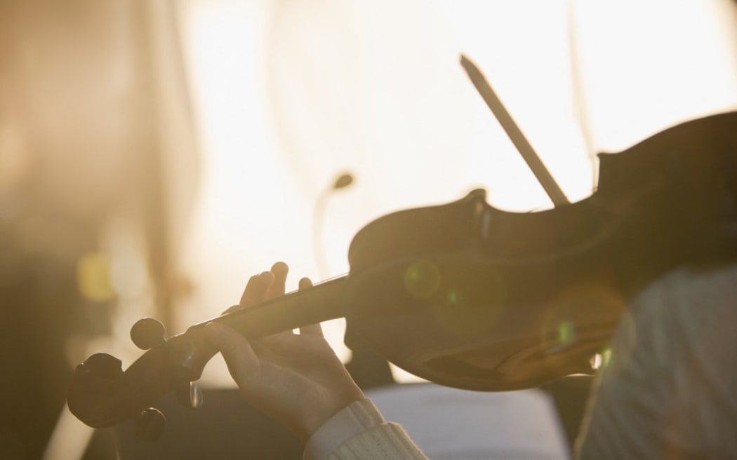 Close up of violinist performing. (Photo by Tom Merton/Caia image/SCIENCE PH / NEW / Science Photo Library via AFP)