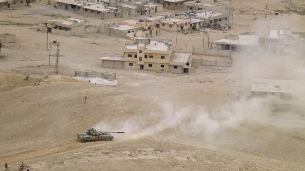 Syrian pro-governement forces hold a position in Palmyra on March 26, 2016, during a military operation to retake the ancient city from the jihadist Islamic State (IS) group.