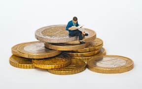 man sitting on coins