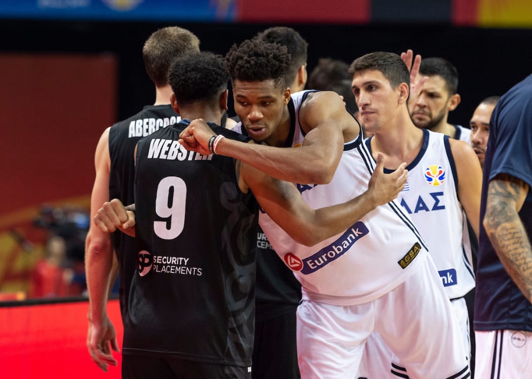 hooting Guard, Corey Webster is given a respectful hug at the end of the match by Greece's Giannis Antetokounmpo.