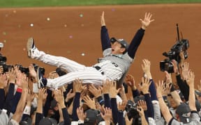 Hideki Kuriyama, a manager of the Japan National Team is lifted in the air after Japan defeated the U.S.A. in the 2023 World Baseball Classic final.