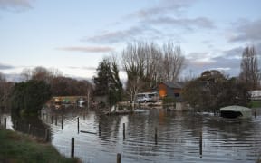 Pouesi and Hilary Fitisemanu's Riwaka home surrounded by floodwater from the Motueka River.