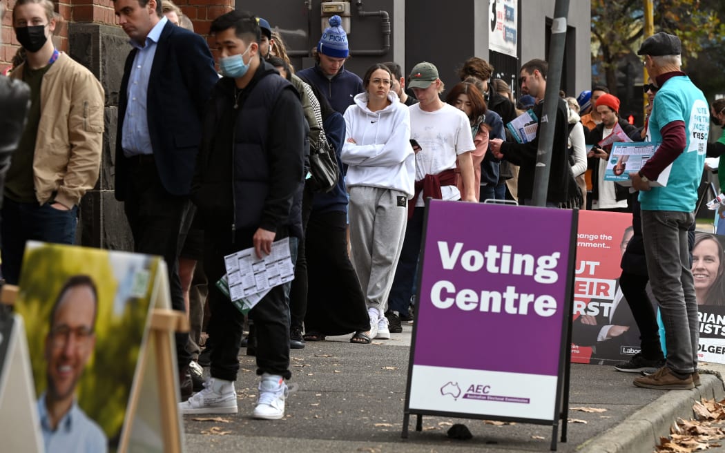People queue outside a pre-polling centre as they vote early in Melbourne on 20 May 2022, ahead of the 21 May general election.