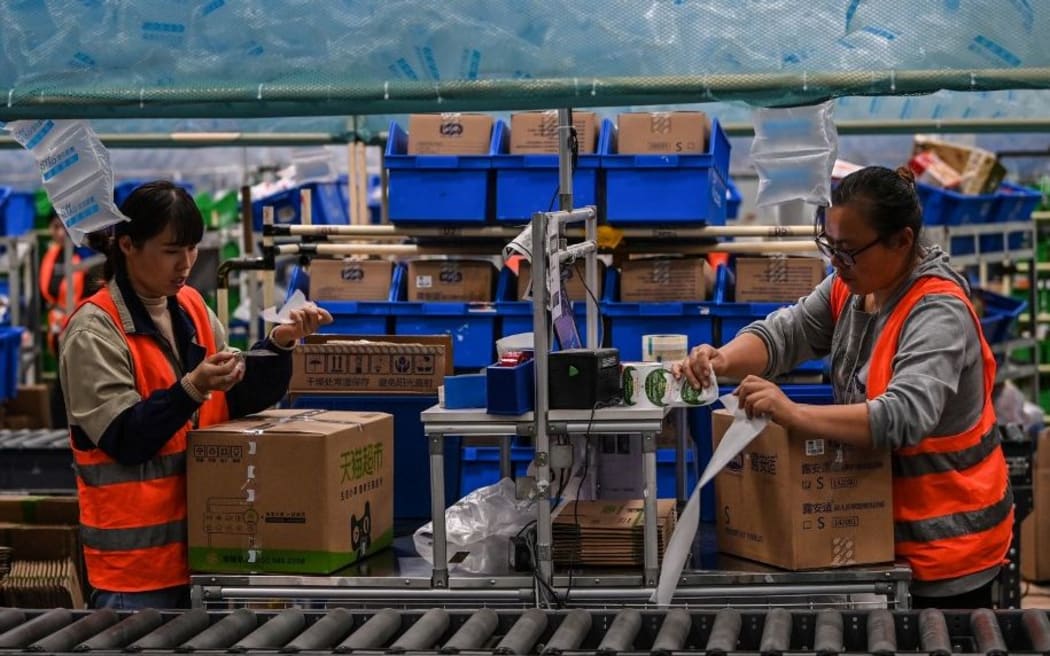 In this picture taken on November 6, 2020, employees work in the warehouse of Cainiao Smart Logistics Network, the logistics affiliate of e-commerce giant Alibaba, in Wuxi, China's eastern Jiangsu province