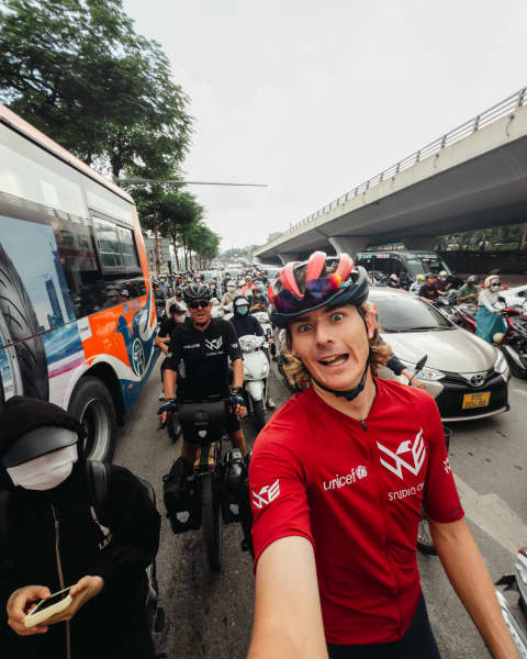 Joshua and George Kohler cycling in the chaotic streets of Vietnam.
