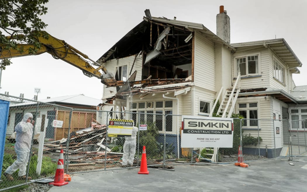 Demolition of 42 Morris Street by Simkin Construction. Men in safety gear because of asbestos in building.