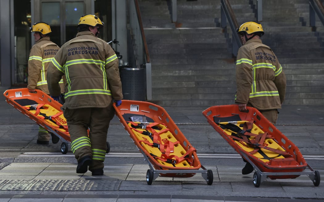 Members of the emergency services bring stretchers at the scene of the Fields shopping center in Copenhagen, Denmark, on 3 July, 2022 following a shooting. - Gunfire in a Copenhagen mall left "several dead," and several wounded Danish police said.